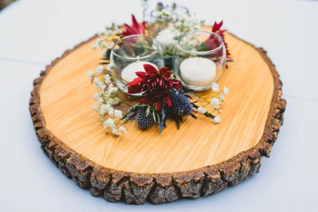 A wooden board with flowers and candles on it